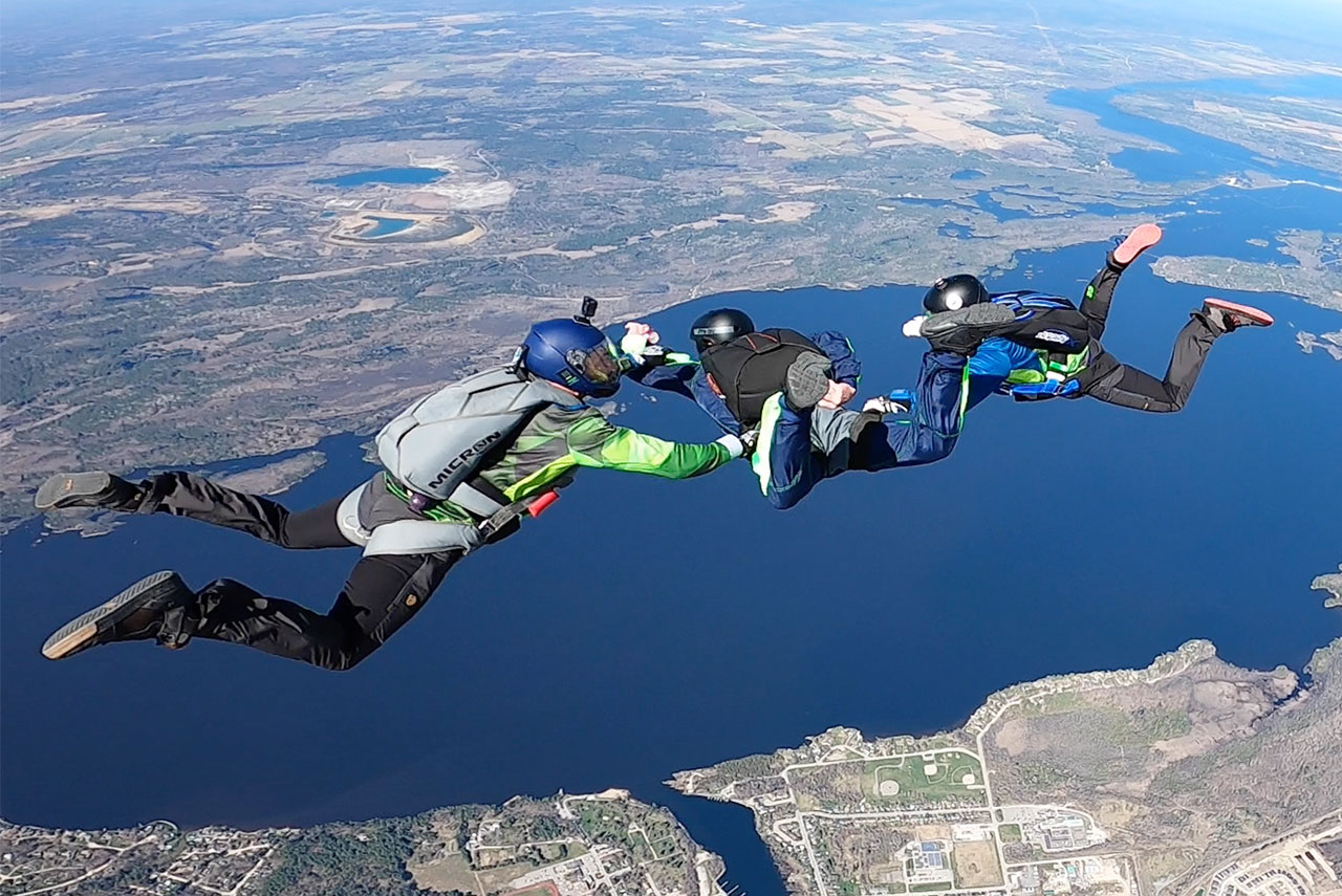 PFF skydiving student learning to skydive with two instructors at Parachute Ottawa in Ontario